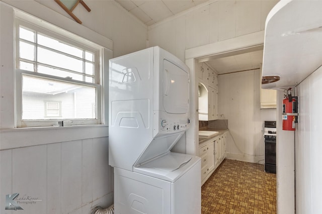 bathroom featuring stacked washer and clothes dryer