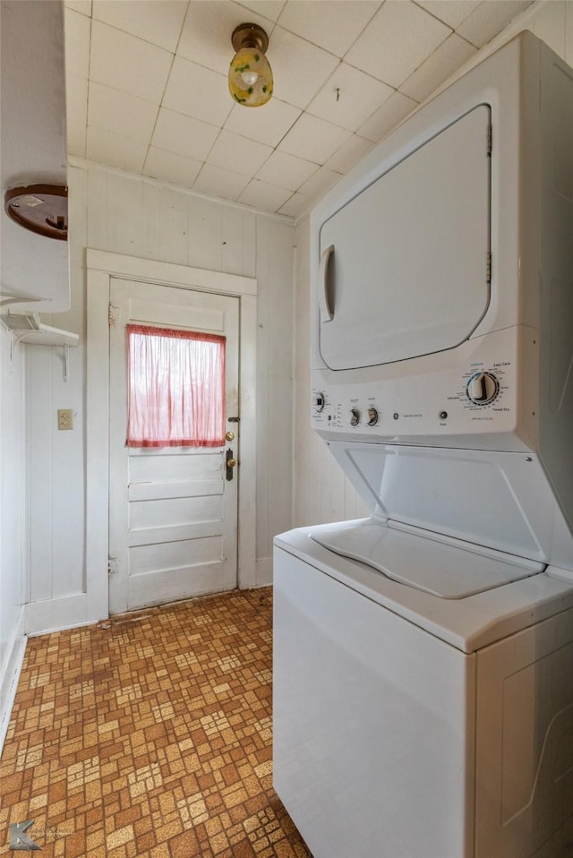 laundry area featuring stacked washer / dryer