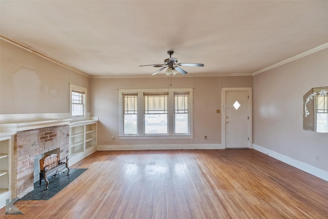 unfurnished living room featuring ceiling fan, crown molding, light hardwood / wood-style flooring, and built in shelves