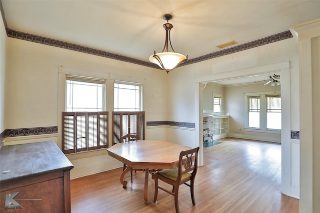 dining area featuring light wood-type flooring and ceiling fan