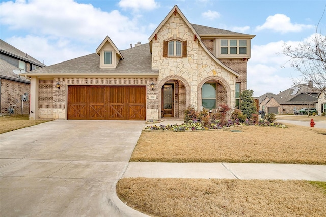 view of front of home featuring a garage and a front yard