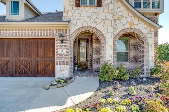 300 Ben Thomas St, Burleson, TX 76028 - entrance to property with stone siding, an attached garage, brick siding, concrete driveway, and roof with shingles