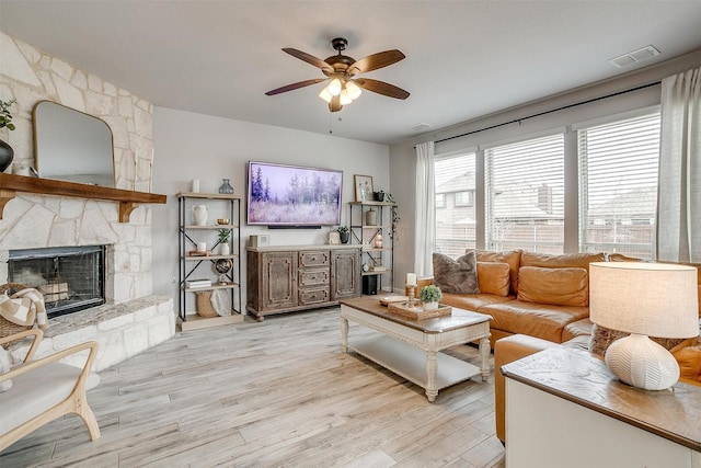 300 Ben Thomas St, Burleson, TX 76028 - living room with a ceiling fan, light wood-style flooring, and a fireplace