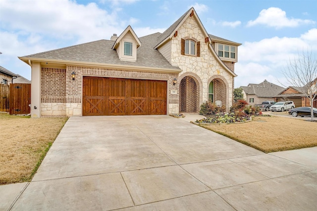 view of front of home with a garage and a front lawn