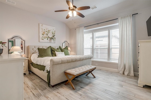 bedroom featuring ceiling fan, vaulted ceiling, and light wood-type flooring