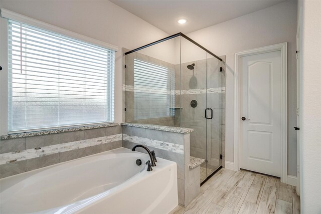 bedroom with ceiling fan, light hardwood / wood-style floors, and connected bathroom