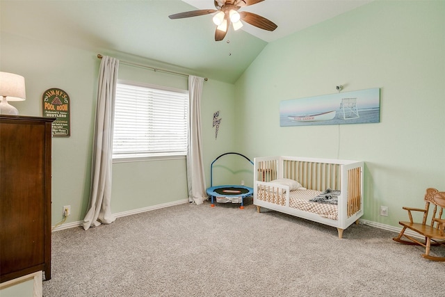 bedroom featuring carpet, lofted ceiling, a ceiling fan, a nursery area, and baseboards