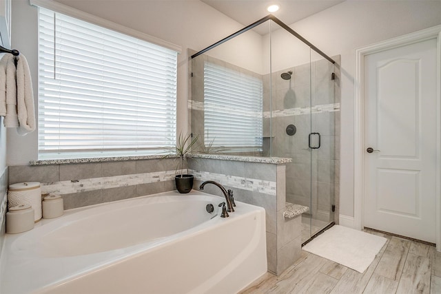 bathroom featuring independent shower and bath