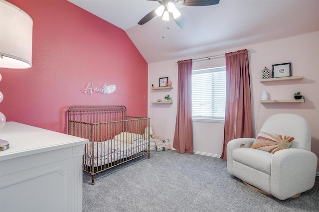 bedroom featuring lofted ceiling, ceiling fan, a nursery area, and light carpet