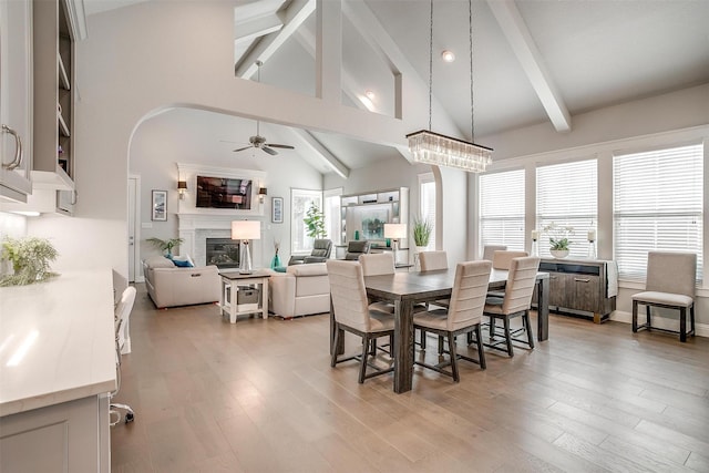 dining space with vaulted ceiling, ceiling fan, and light hardwood / wood-style floors