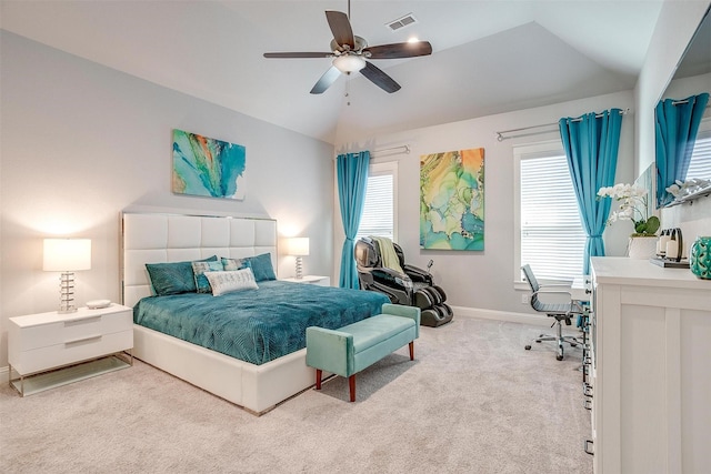 bedroom featuring lofted ceiling, ceiling fan, light carpet, and multiple windows