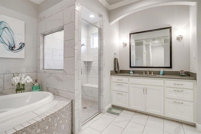 bathroom featuring independent shower and bath, ornamental molding, and vanity