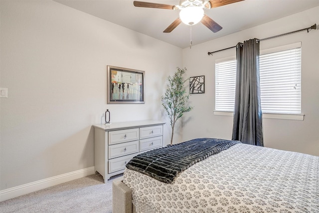 bedroom with ceiling fan and light carpet