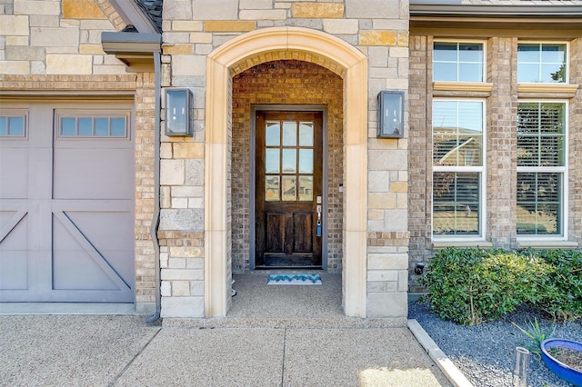 doorway to property with a garage