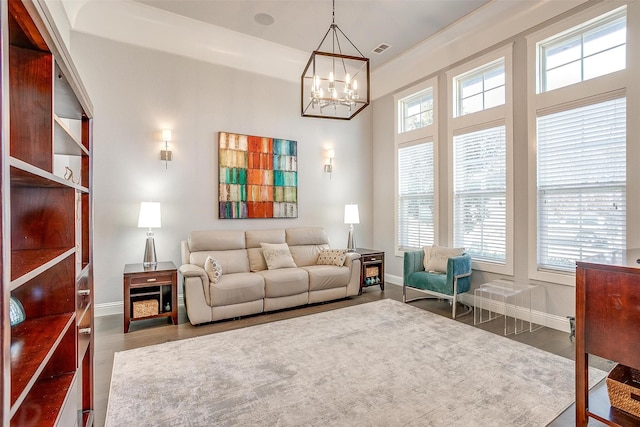 living room with dark hardwood / wood-style flooring and a notable chandelier