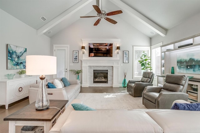 living room with ceiling fan, light hardwood / wood-style flooring, and lofted ceiling with beams