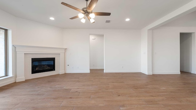 4601 Timberdrift St, Midlothian, TX 76065 - unfurnished living room with a ceiling fan, light wood finished floors, a tiled fireplace, recessed lighting, and baseboards