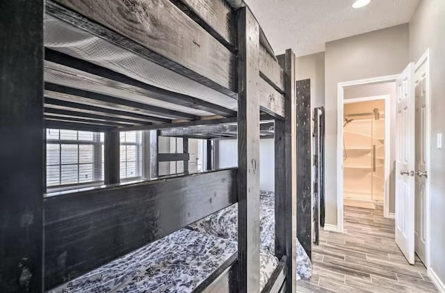 corridor with a textured ceiling and beam ceiling