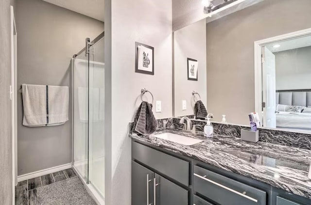 bathroom with vanity and a shower with door