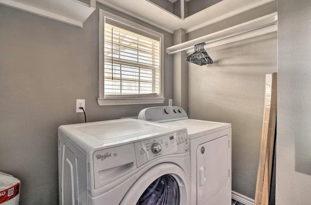 clothes washing area featuring washer and clothes dryer