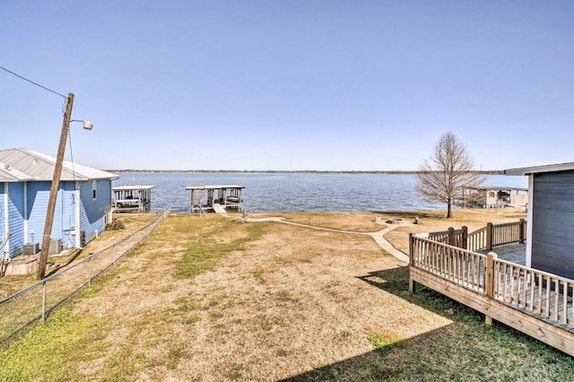 view of yard with a boat dock and a water view