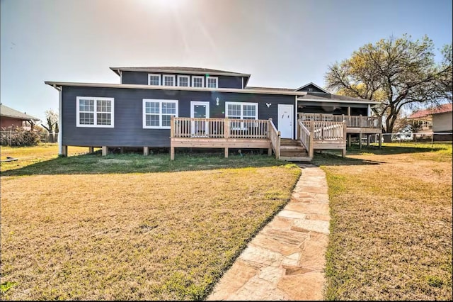 back of house with a deck and a yard