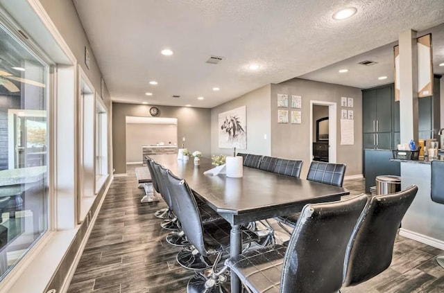 dining space with a textured ceiling