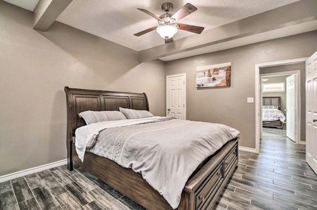 bedroom with a textured ceiling, ceiling fan, and beam ceiling