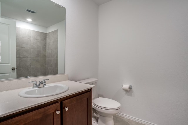 bathroom featuring toilet, tile patterned flooring, and vanity