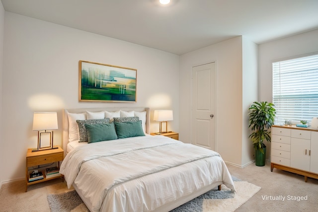 bedroom with light colored carpet