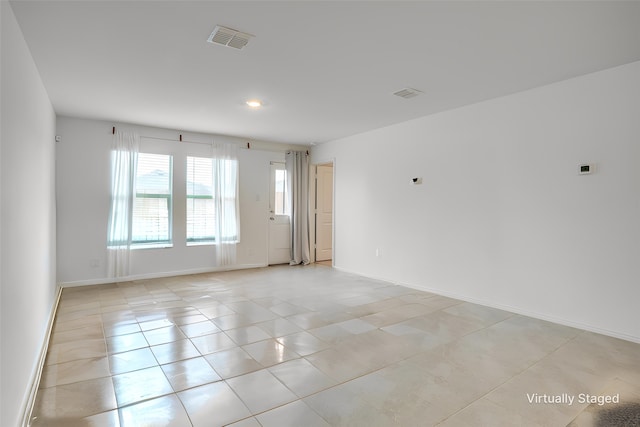 spare room featuring light tile patterned floors