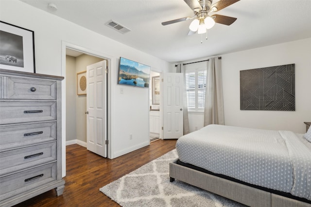 bedroom with ceiling fan, dark hardwood / wood-style floors, and ensuite bathroom