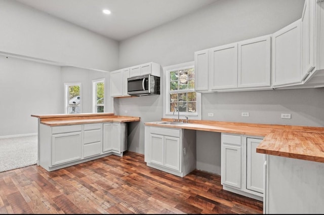 kitchen featuring sink, white cabinetry, and butcher block counters