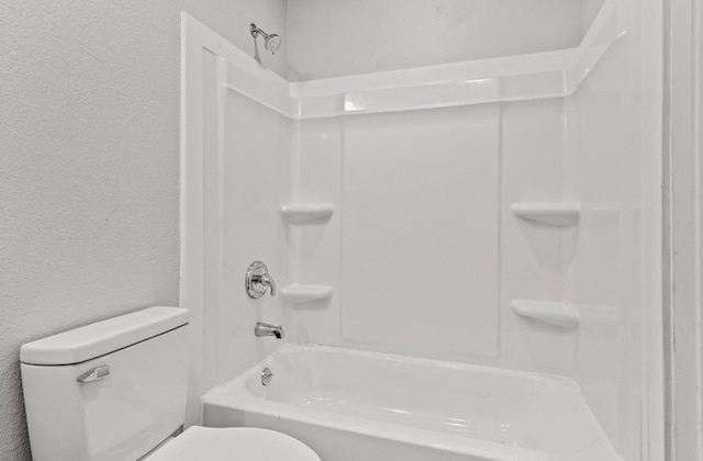 bathroom with toilet and bathtub / shower combination