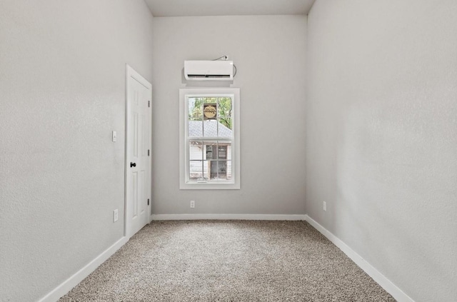 carpeted spare room featuring an AC wall unit