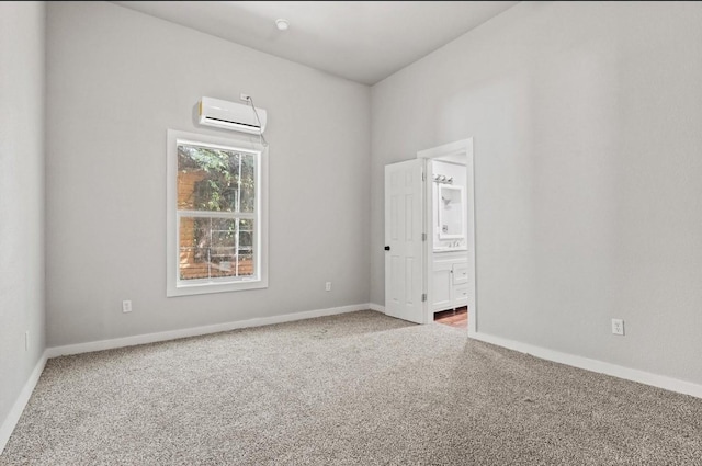 empty room with an AC wall unit and carpet flooring