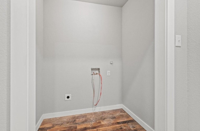 clothes washing area with hardwood / wood-style flooring, hookup for a gas dryer, electric dryer hookup, and hookup for a washing machine