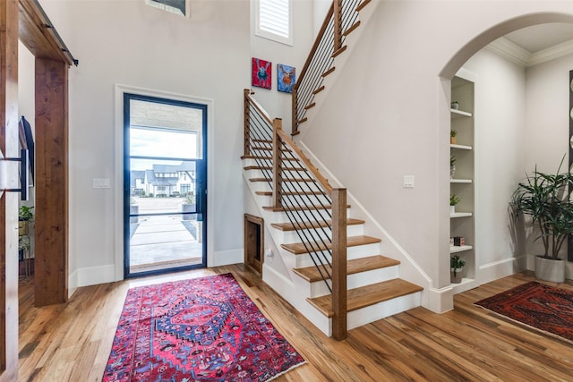 entryway featuring light hardwood / wood-style flooring and crown molding