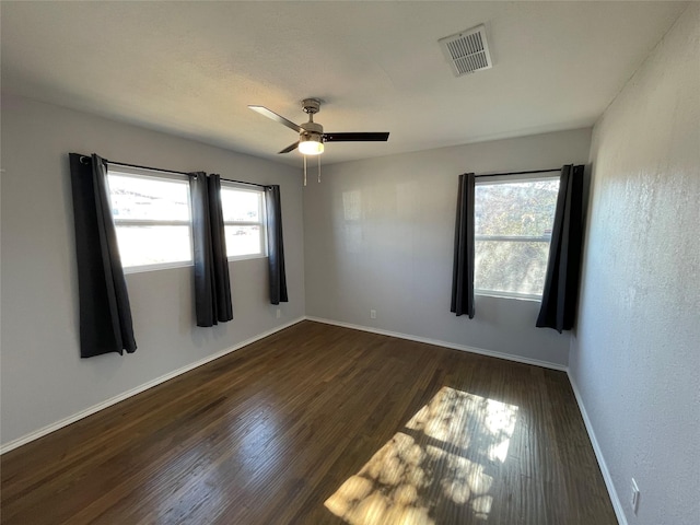 empty room featuring dark hardwood / wood-style floors and ceiling fan