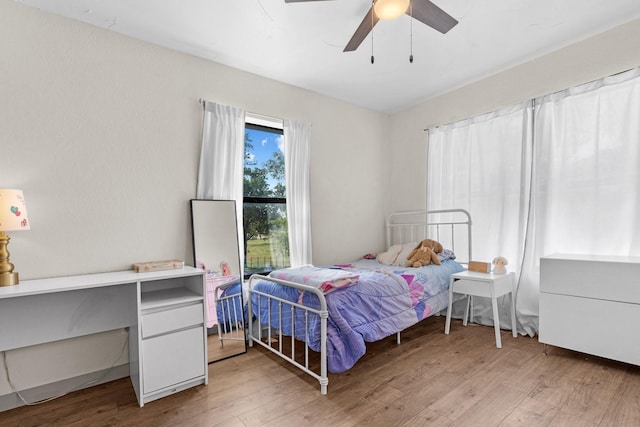 bedroom with light wood-type flooring and ceiling fan