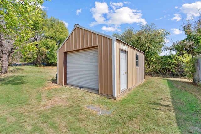 view of outbuilding with a garage and a yard