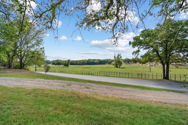 view of home's community featuring a rural view and a yard