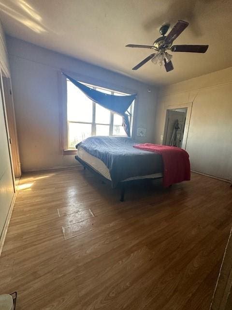 bedroom featuring ceiling fan and hardwood / wood-style floors