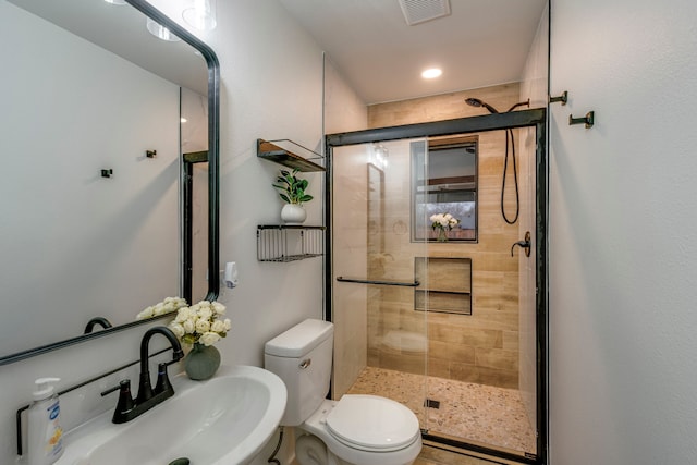 bathroom with toilet, sink, and walk in shower