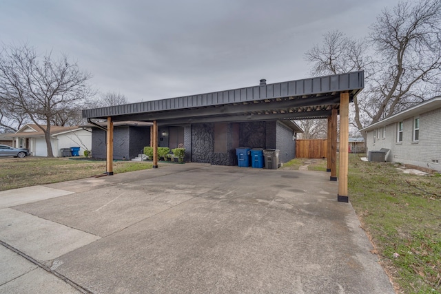 view of car parking with a carport and a yard