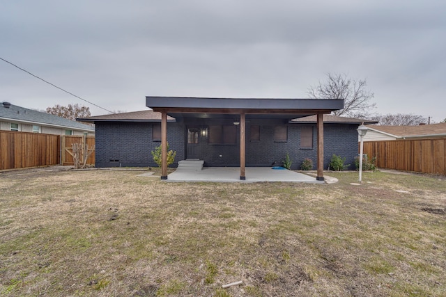 rear view of house featuring a patio area and a yard