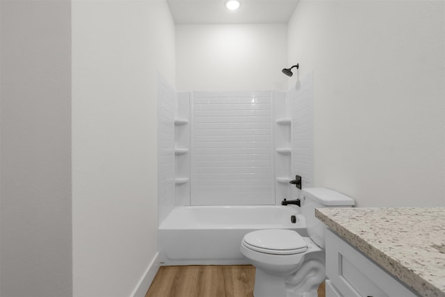 full bathroom with tub / shower combination, vanity, wood-type flooring, and toilet