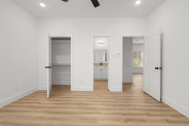 unfurnished bedroom featuring ceiling fan, connected bathroom, and light hardwood / wood-style floors