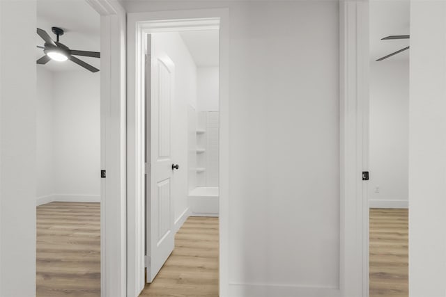 hallway with light wood-type flooring