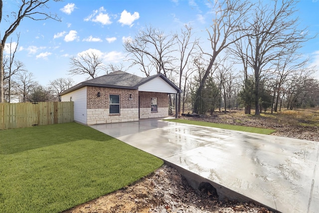 view of home's exterior with a patio area and a lawn